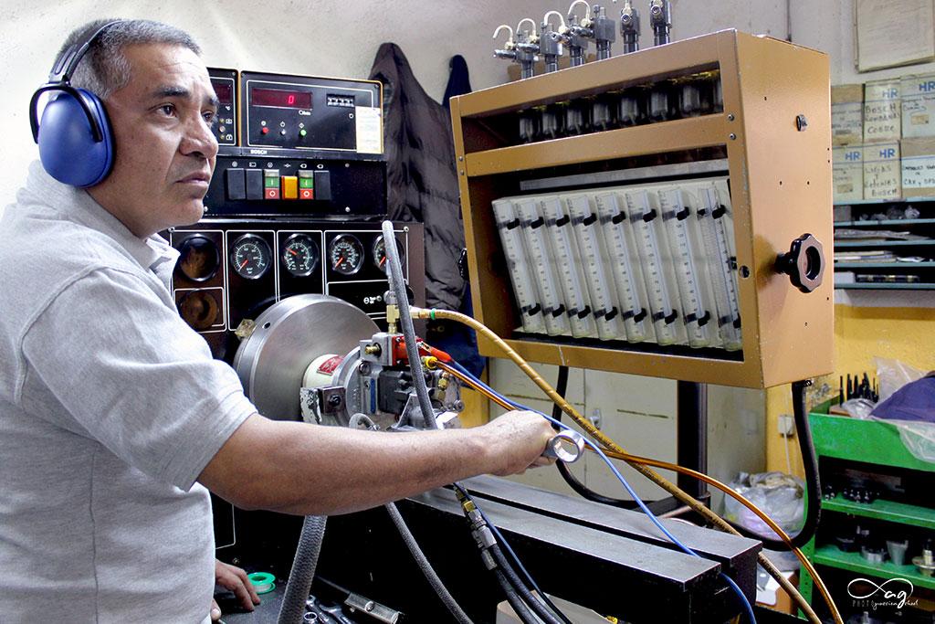 General workshop scene showing injector diagnostic equipment in use