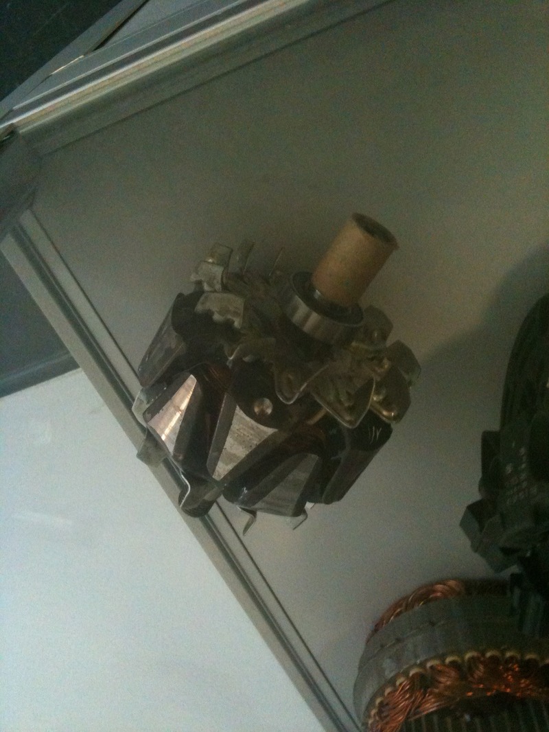 Lundell claw-pole alternator rotor showing finger-shaped poles and copper slip rings on display